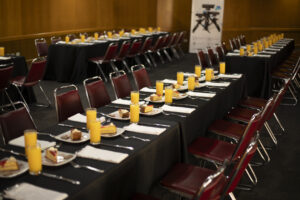 Snídaňový stůl s ovocnými šťávami a pečivem.