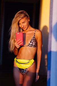 Woman in leopard bikini taking a selfie