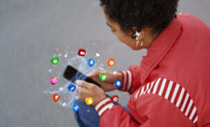 Person using smartphone with social media icons